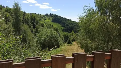 a wooden fence with a view of a hill at Vikendica Kop in Kopaonik