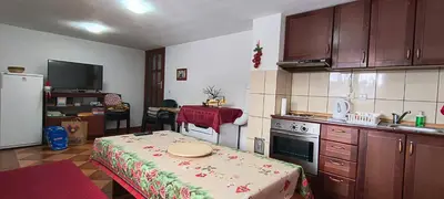 a kitchen with a table in the middle of it at Vikendica Kop in Kopaonik