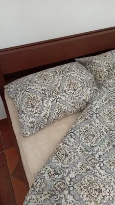 a bed with two pillows on top of it at Vikendica Kop in Kopaonik