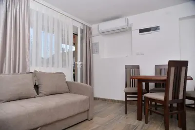 a living room with a couch and a table at Apartmani Milovanović in Vrnjačka Banja