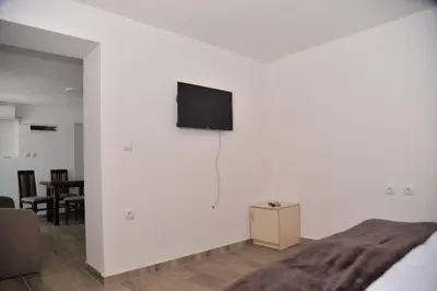 a white wall with a flat screen tv on a wall at Apartmani Milovanović in Vrnjačka Banja