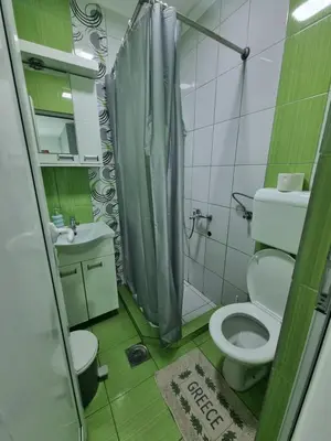 a bathroom with a toilet and a sink and a shower at Bovan GREEN LAKE apartments in Soko Banja