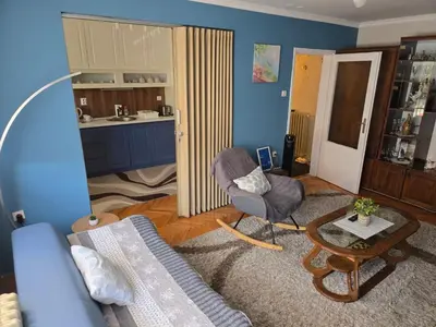 a living room with a couch and a chair and a table at Kingston in Pirot