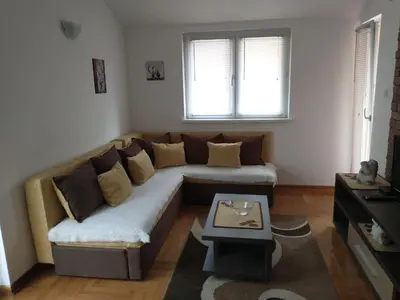 a living room with a couch and a table at Apartment Park in Vrnjačka Banja