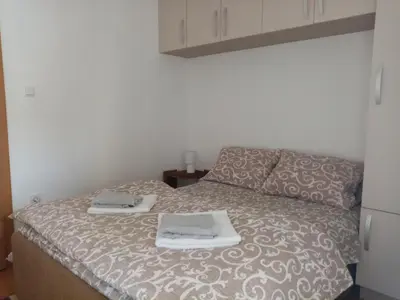 a bedroom with a bed with two towels on it at Apartment Park in Vrnjačka Banja