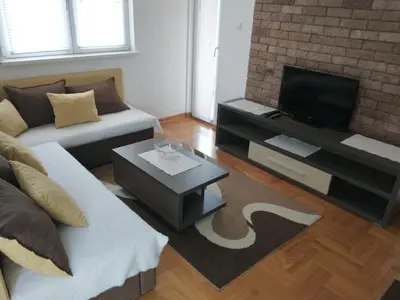 a living room with a couch and a flat screen tv at Apartment Park in Vrnjačka Banja