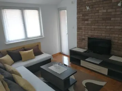 a living room with a couch and a tv at Apartment Park in Vrnjačka Banja