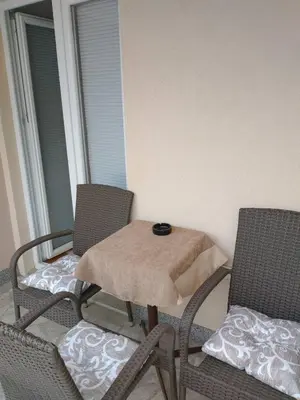 a table and two chairs on a balcony with a table and chairs at Apartment Park in Vrnjačka Banja