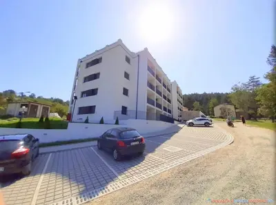 two cars parked in a parking lot in front of a building at Studio Bogdanovic in Vrnjačka Banja