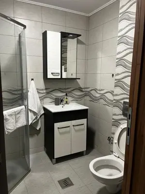 a bathroom with a toilet and a sink and a mirror at Studio Bogdanovic in Vrnjačka Banja