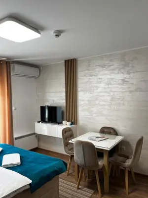 a room with a bed and a table and chairs at Studio Bogdanovic in Vrnjačka Banja
