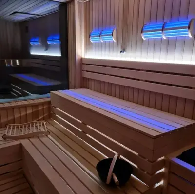 a sauna with blue lights on the inside of it at Apartman ZoneS - Zoned in Kopaonik