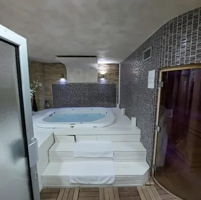 a large bathroom with a tub with white towels at Apartman ZoneS - Zoned in Kopaonik