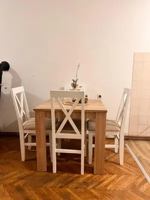 a dining room table with two chairs and a white table at Apartman Lili in Soko Banja