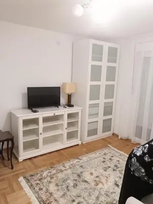 a living room with a tv and a white cabinet at Apartman Sveta in Vrnjačka Banja