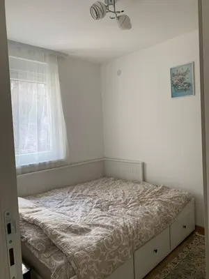 a bed in a bedroom with a window at Apartman Sveta in Vrnjačka Banja