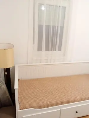 a bed in a room with a window at Apartman Sveta in Vrnjačka Banja