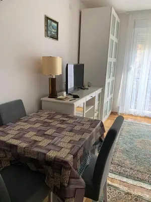 a room with a table with a computer on a desk at Apartman Sveta in Vrnjačka Banja