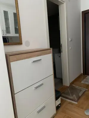 a dresser in a room with a mirror at Apartman Sveta in Vrnjačka Banja