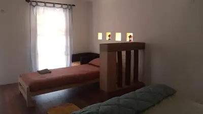 a bedroom with two beds and a window at Village house Moo Moo in Vranje