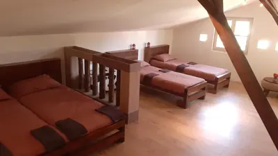 a room with three beds and a stair case at Village house Moo Moo in Vranje