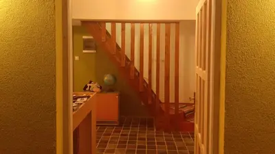 a hallway with a staircase in a house at Village house Moo Moo in Vranje