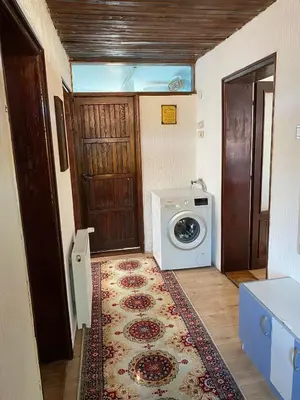 a laundry room with a door and a washing machine at Mićin dom in Pirot