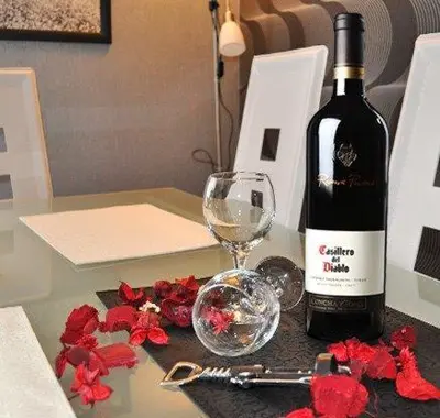 a bottle of wine and a glass on a table at Lux apartment A38, Kraljevi čardaci, Kopaonik in Kopaonik