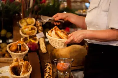 a person preparing food in baskets on a table at Silver View in Kopaonik