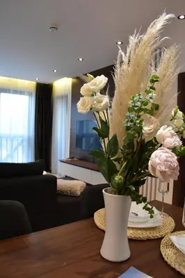 a vase with flowers on a table in a living room at Silver View in Kopaonik