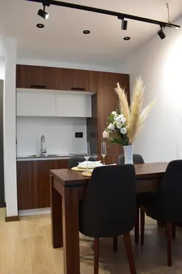 a kitchen with a wooden table with a vase of flowers at Silver View in Kopaonik