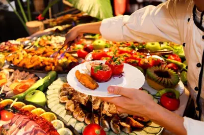 a person holding a plate of food on a buffet at Silver View in Kopaonik