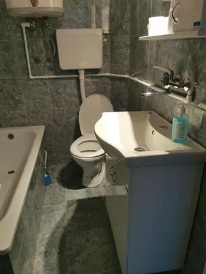 a bathroom with a white toilet and a sink at Apartmani Manila, Vrnjačke terme-popust, SPA centar Pegaz-popust, garažno mesto in Vrnjačka Banja