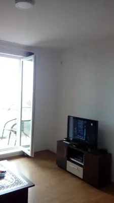 a living room with a flat screen tv on a stand at Apartman Andjela in Soko Banja