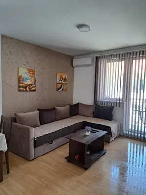 a living room with a couch and a table at Apartman Andjela in Soko Banja