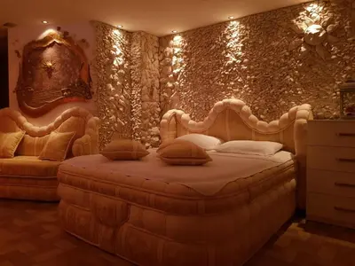 a bedroom with a bed and a wall with lights at FARAON pn 3 in Paraćin