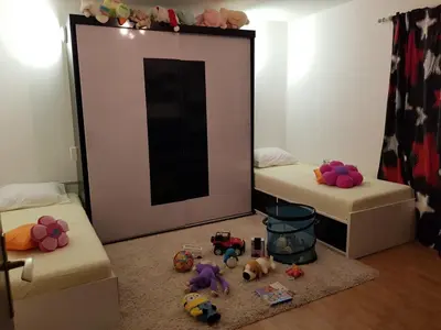 a room with two beds with toys in front of a mirror at FARAON pn 3 in Paraćin