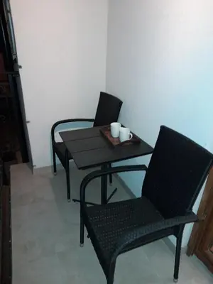 two chairs and a table and a table and chairs at Apartman Emma Vrnjačka Banja in Vrnjačka Banja