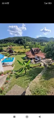 an overhead view of a yard with a house and a pool at Vikendica Darija in Kraljevo