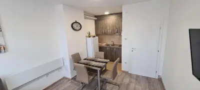 a kitchen with a table and chairs in a room at Apartmani Lavanda in Soko Banja