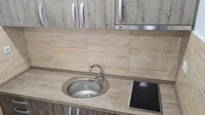 a kitchen counter with a sink in a kitchen at Apartmani Lavanda in Soko Banja