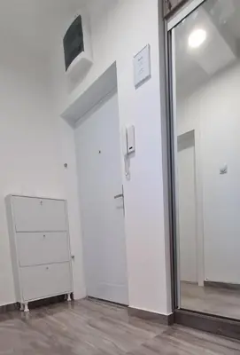 a white room with a door and a mirror at Apartmani Lavanda in Soko Banja
