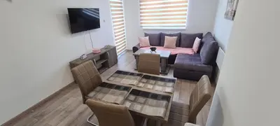 a living room with a couch and a table at Apartmani Lavanda in Soko Banja