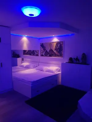 a bedroom with a bed with a blue light at FARAON pn 1 in Paraćin