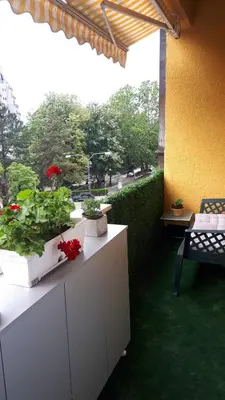 a balcony with two potted plants on a table at FARAON pn 1 in Paraćin