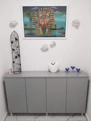 a painting of a head on a wall above a dresser at FARAON pn 1 in Paraćin