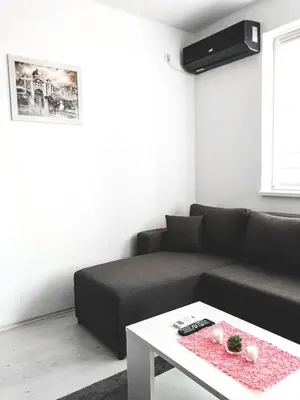 a living room with a couch and a table at Apartman DEA in Soko Banja
