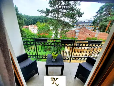 a balcony with a table and chairs and a view at Apartman Korićanac Vrnjačka Banja in Vrnjačka Banja