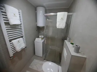 a bathroom with a shower and a toilet and a sink at Apartman Korićanac Vrnjačka Banja in Vrnjačka Banja