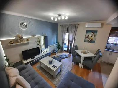 a living room with a couch and a table at Apartman Korićanac Vrnjačka Banja in Vrnjačka Banja